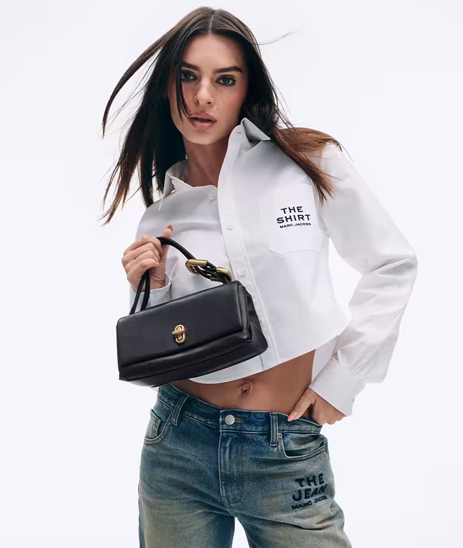 Emiliy Ratajkovski holding a small dual bag